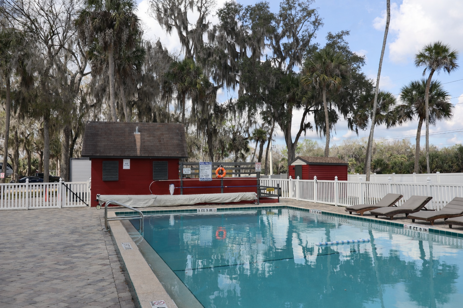 Heated swimming pool with loungers at Cape Kennedy RV Resort
